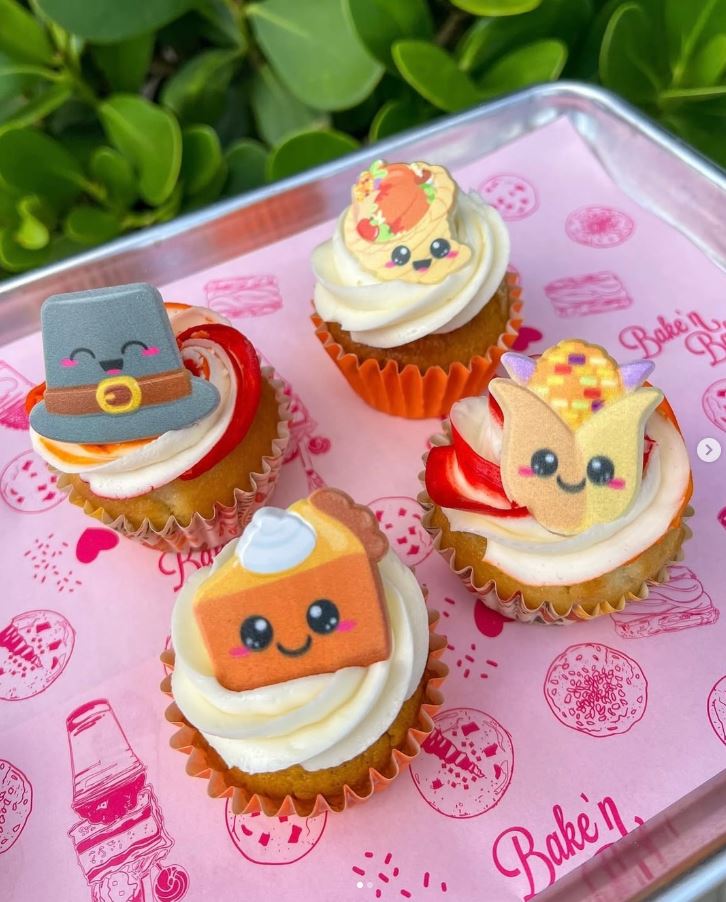 Bake'n cupcakes served on pink custom greaseproof paper with a repeating bakery logo pattern
