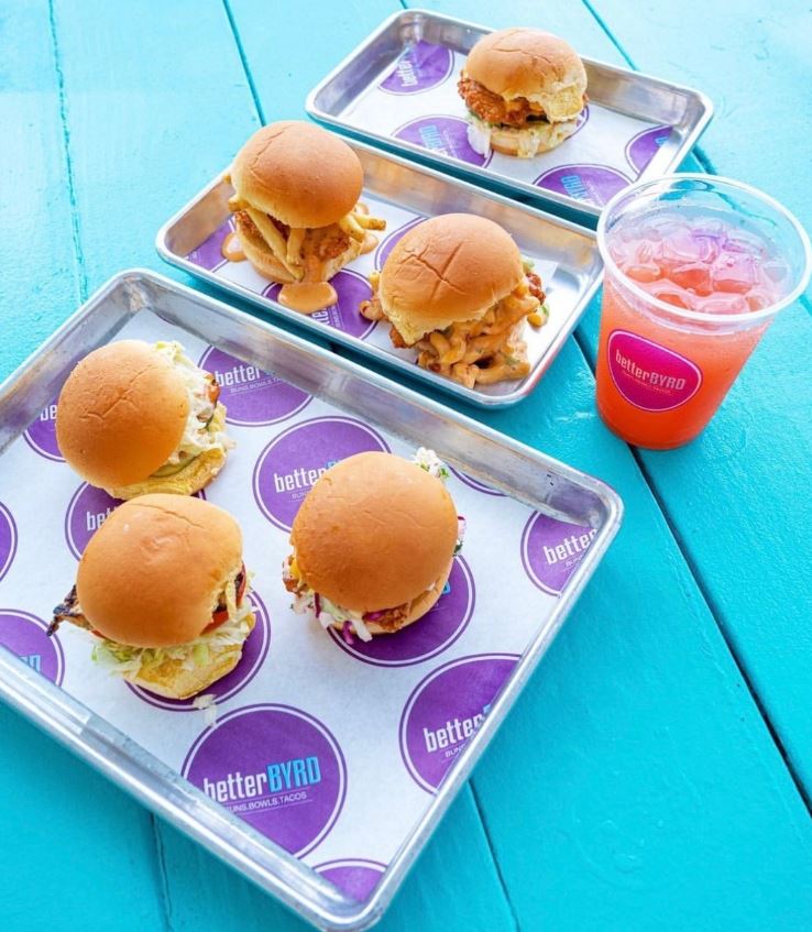 Better Byrd sliders served on custom greaseproof paper with a purple repeating logo pattern